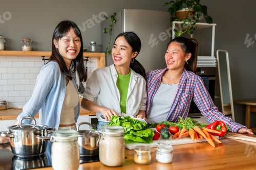 Preview: Happy beautiful chinese women friends bonding at home