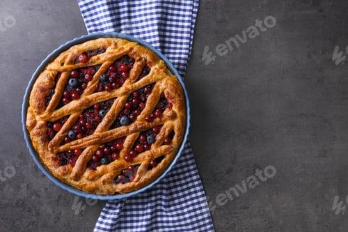Preview: Delicious currant pie and fresh berries on grey table, top view. Space for text