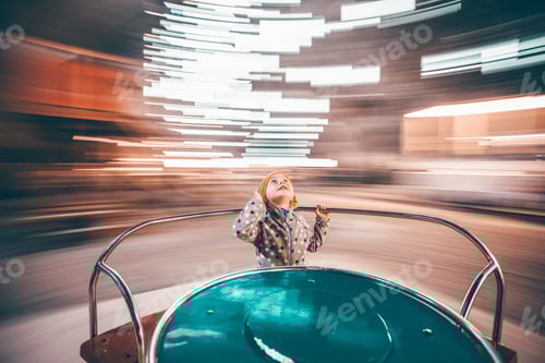 Preview: Child having fun on merry-go-round