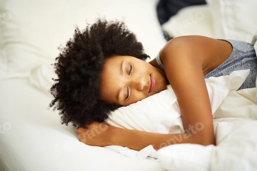 Preview: Sleep well. Its good for your health. Shot of a young woman sleeping in her bed at home.