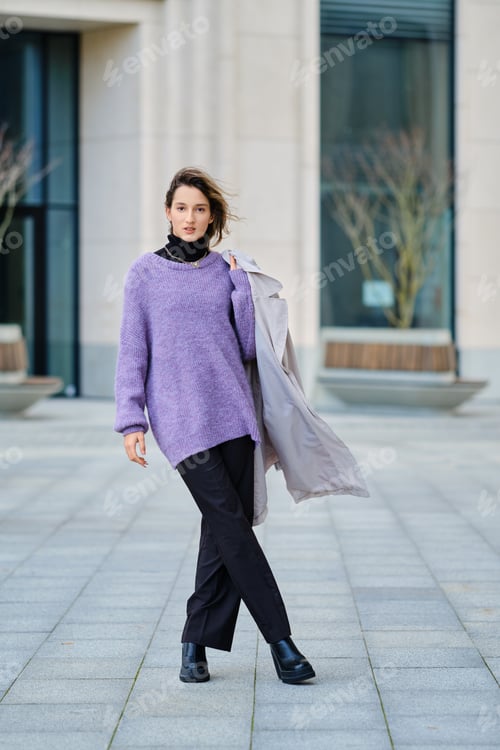 Preview: Street portrait of a woman with raincoat over her shoulder