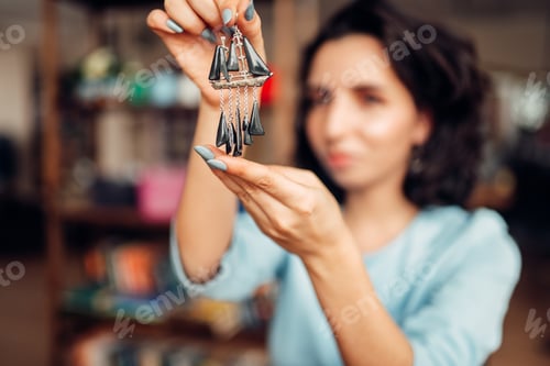 Preview: Female master with pliers making handmade earrings