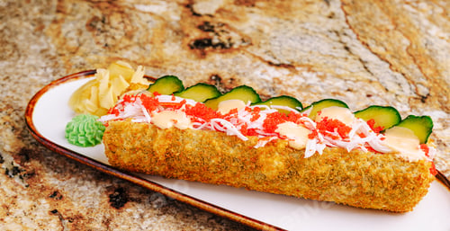 Preview: Delicious sushi roll with crab, cucumber, and colorful toppings on a plate