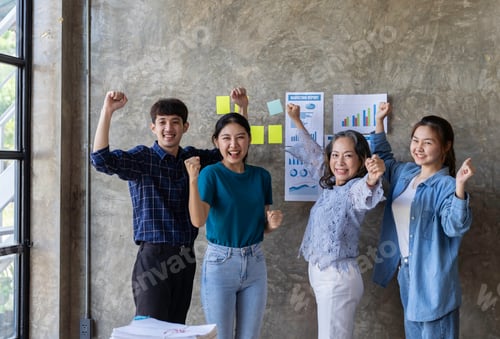 Preview: Group of young Asian businessmen raising their hands congratulating the success of the project. Pass