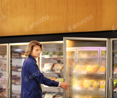 Preview: Man Choosing Frozen Food From A Supermarket Freezer