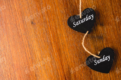 Preview: Heart of black wood with days of the weekend written on it.