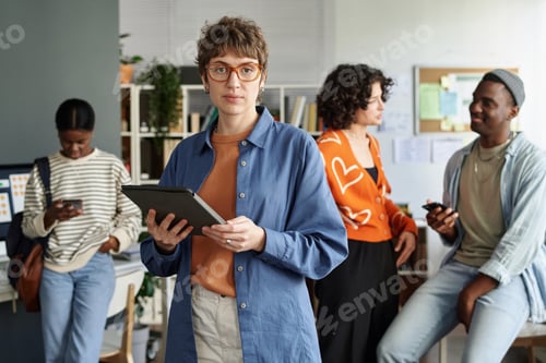 Preview: Portrait of Woman Holding Tablet in Modern Office Setting