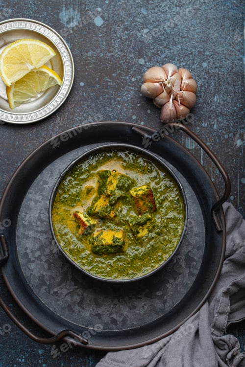 Preview: Indian dish Palak Paneer in bowl on rustic stone table