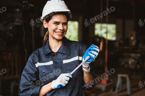 Preview: Portrait of happy female industrial worker in white hard hat smiling
