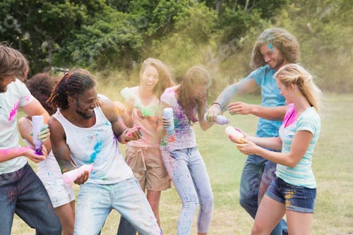 Preview: Friends having fun with powder paint on a sunny day