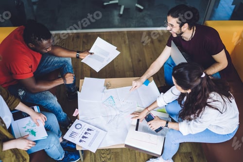 Preview: Multiethnic group of people analyzing graphs and working together