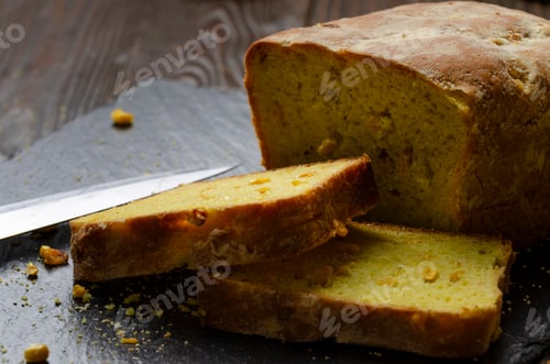 Preview: Homemade cornbread loaf and slices on kitchen table
