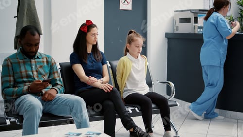Preview: Portrait of young mother with little girl sitting in hospital reception lobby