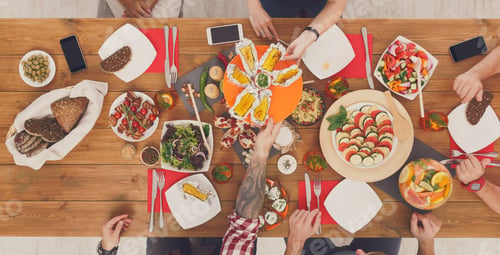 Preview: People eat grilled corn at served table dinner party