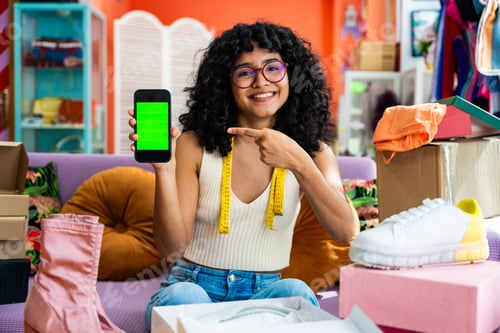 Preview: Beautiful young hispanic woman managing her home e-commerce business from home