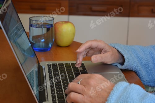 Preview: Woman using laptop computer, hands typing on keyboard, selective focus, low angle view