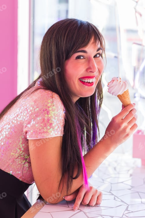 Preview: Summer, youth and dessert concept - Pretty girl enjoying an ice-cream cone in cafe