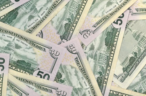 Preview: Many US fifty dollar bills on flat background surface close up