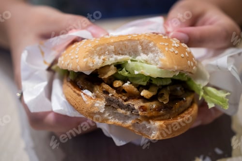Preview: Woman Hands Holding Delicious Burger. Hamburger food concept