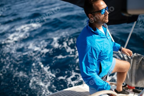 Preview: Handsome strong man sailing with his boat