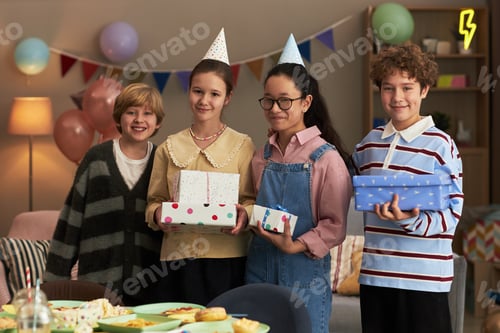 Preview: Group of Diverse Teenagers Smiling and Holding Birthday Presents Indoors