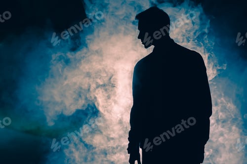 Preview: The man silhouette standing in the smoke. evening night time