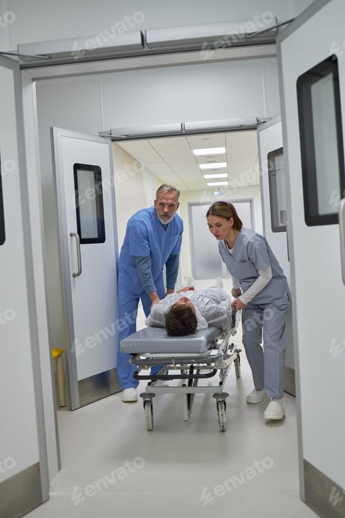 Preview: Middle Aged Man and Woman Transporting Patient