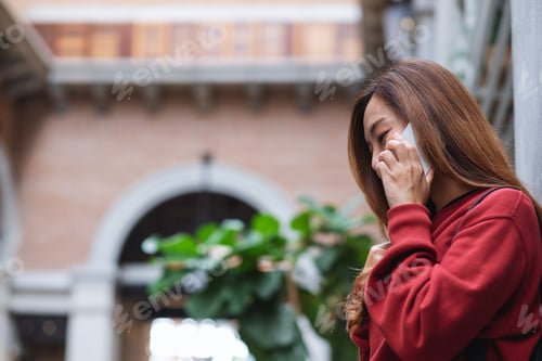 Preview: A young asian woman talking on mobile phone while traveling and sightseeing around the city