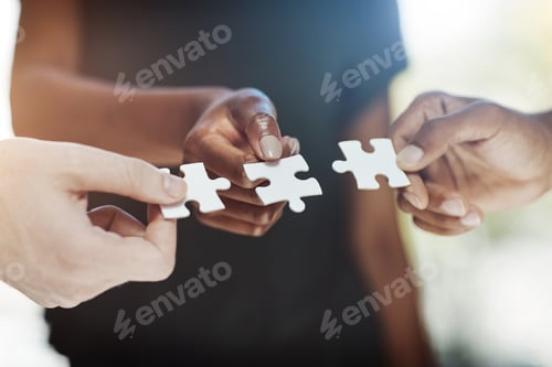 Preview: Cropped shot of a work group connecting pieces of a puzzle