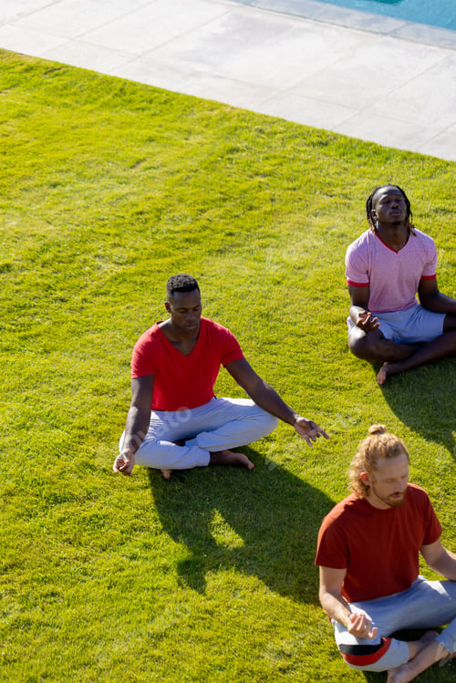 Preview: Group of diverse friends doing yoga and meditating in garden, copy space