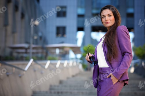 Preview: Beautiful businesswoman with sunglasses on city street. Space for text