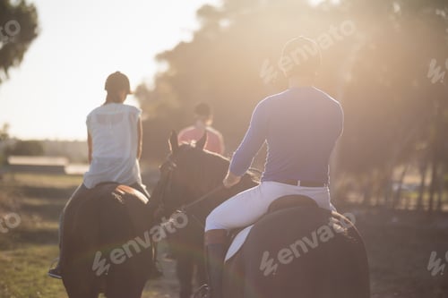 Preview: Trainer training women in riding horses at barn