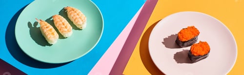 Preview: fresh nigiri with shrimps and red caviar on blue, pink, orange background, panoramic shot