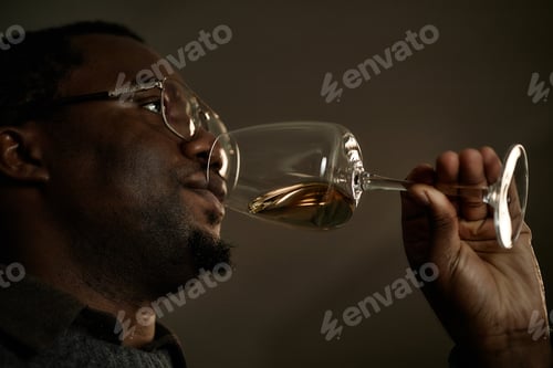 Preview: Middle Aged Black Man Smelling Wine While Testing Beverage for Quality