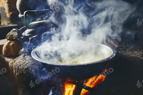 Preview: Preparation rice and curry meal. Cooking on fire pit in traditional home kitchen in Sri Lanka.