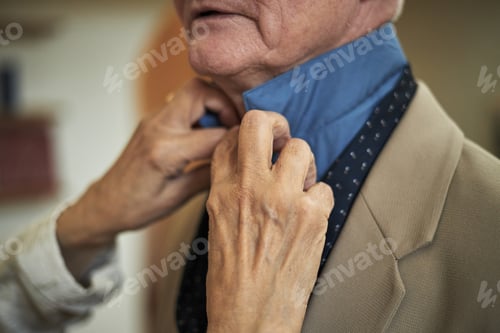 Preview: Adjusting Collar for Elderly Gentleman in Blue Shirt