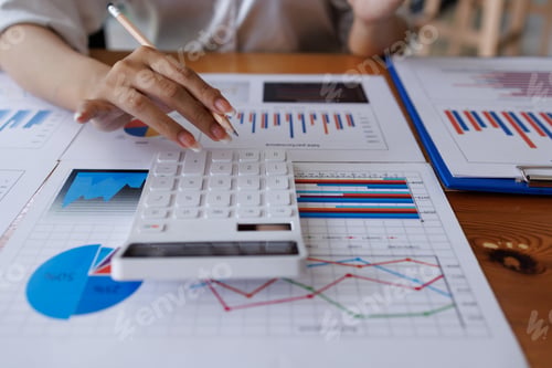 Preview: Close up of businesswoman Accounting using calculating income-expenditure and analyzing real estate