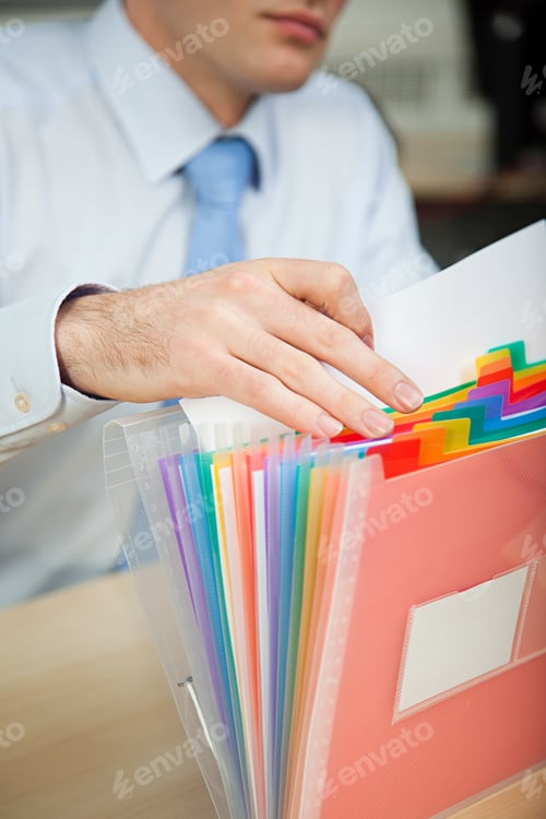 Preview: Office worker filing document
