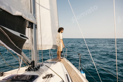 Preview: Young man enjoying a sailboat trip on the open sea