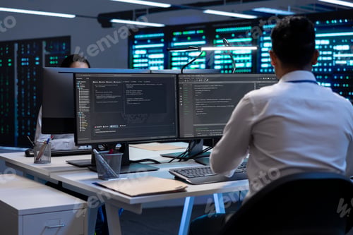 Preview: Technician using computer to troubleshoot hardware in server hub