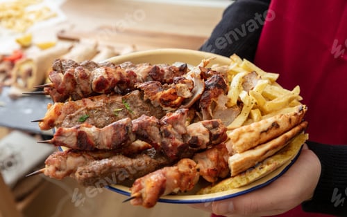 Preview: Grill meat skewer, Souvlaki chicken and pork, kebab doner served in a plate, close up. Greek food