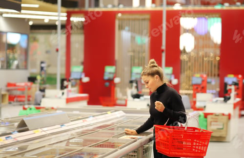 Preview: Woman Choosing Frozen Food From A Supermarket Freezer