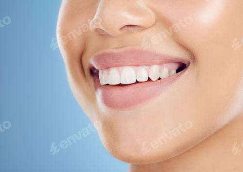 Vista previa: Teeth, smile and mouth of a woman for dental care isolated on a blue background in studio. Healthca