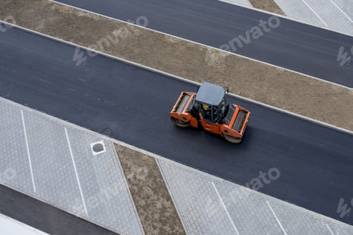 Preview: High angle view of a road-roller on the fresh asphalt at daytime