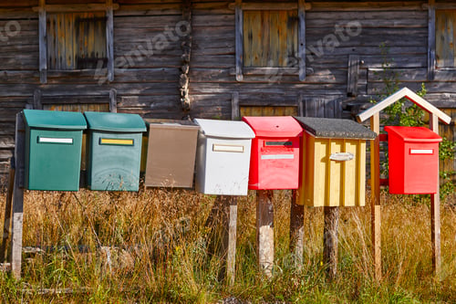 Preview: Traditional colorful vintage mailboxes in the countryside. Horizontal