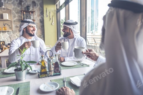 Preview: Three business men having a tea in Dubai wearing traditional emirati clothes