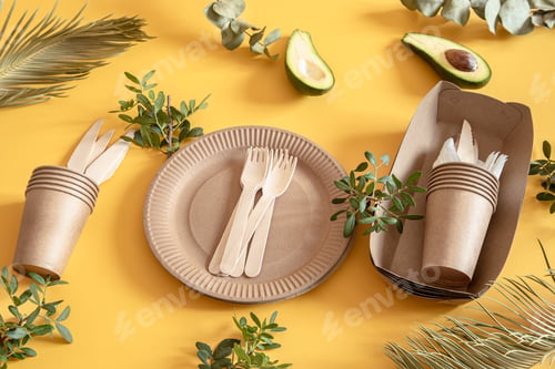 Preview: eco friendly disposable dishes made paper on an orange background.