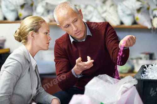 Preview: This is what they should feel like in your hand. Shot of two people in a plastic factory.