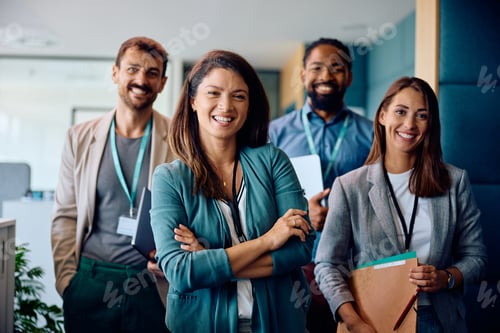 Preview: Happy multiracial business team in the office looking at camera.
