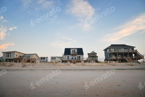 Preview: Row of various sized beach cottage vacation homes to rent or buy on the ocean